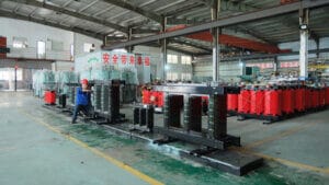 Baitong Electric factory floor: Professional workers assembling high-efficiency cast resin dry type transformers in a clean, large-scale manufacturing facility.
