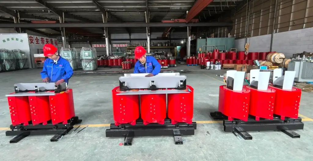 Professional workers assembling high-quality copper windings and silicon steel cores for S11-M oil-immersed transformers at the factory.