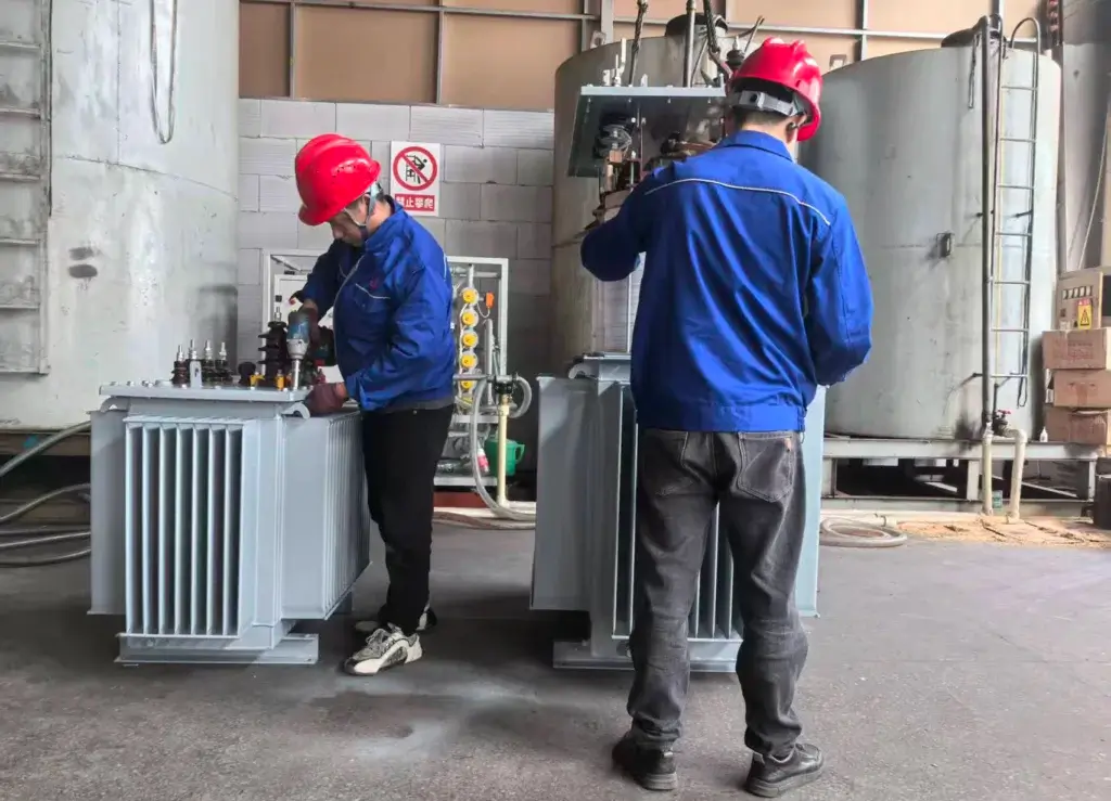 Baitong Electric technicians inspecting the tank sealing before filling oil in a 10kV power transformer.