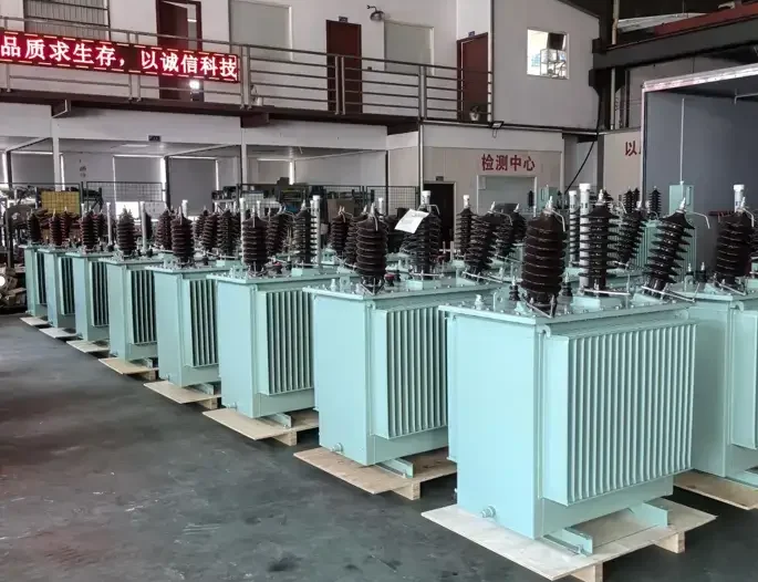 Rows of newly manufactured three-phase oil-immersed distribution transformers ready for shipping at the Baitong Electric facility.