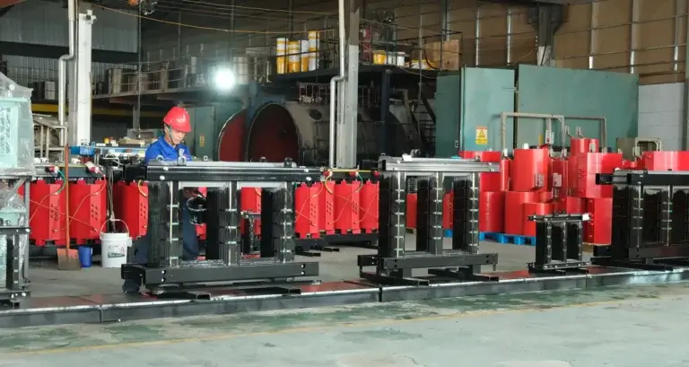 Baitong Electric worker assembling iron cores for cast resin dry type distribution transformers in a certified manufacturing facility.