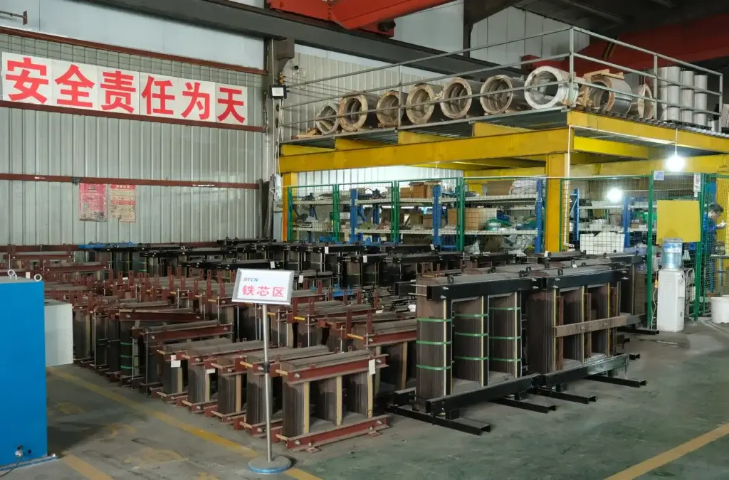 A massive production and storage area showing dozens of assembled dry type transformer core units inside the BTCN manufacturing factory.