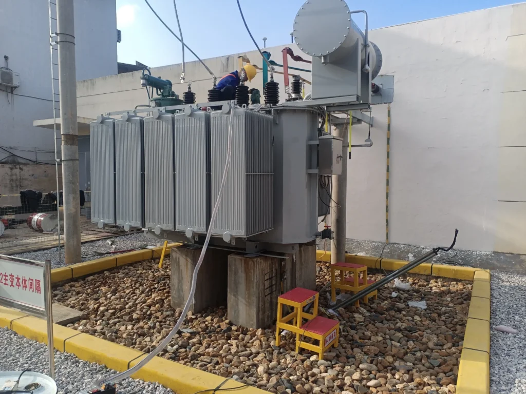 Site prep showing oil filled transformer installation requirements with concrete plinths and gravel containment pit