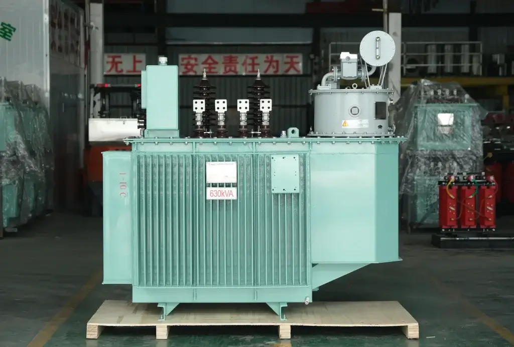 A newly manufactured S13-20kV 630kVA oil immersed transformer resting on a wooden shipping skid inside the Baitong Electric factory, featuring corrugated cooling fins and high-voltage bushings.