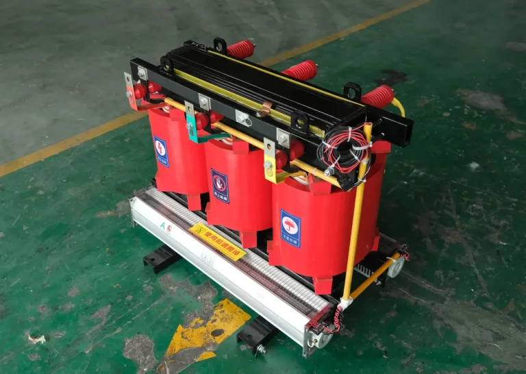 A fully assembled 3 phase dry type transformer featuring red cast resin coils and cooling fans on the Baitong Electric factory floor.