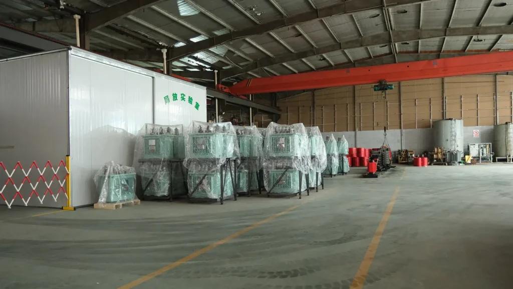 A wide view of the Baitong Electric factory showing a 35 kv oil immersed power transformer inventory next to the partial discharge testing laboratory.