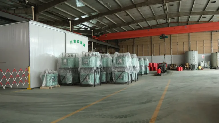 A wide view of the Baitong Electric factory showing a 35 kv oil immersed power transformer inventory next to the partial discharge testing laboratory.
