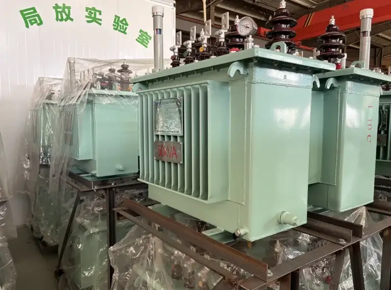 Multiple 50kVA oil immersed fast delivery transformers securely wrapped in plastic and stored on metal racks at the Baitong Electric factory warehouse.