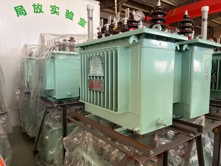 A brand new green s13-20kv 50kva oil immersed transformer waiting outside the partial discharge testing laboratory at the Baitong Electric factory.