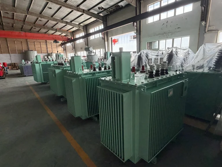 A wide view of the Baitong Electric factory floor demonstrating transformer mass production with rows of green oil immersed units and yellow safety lines.