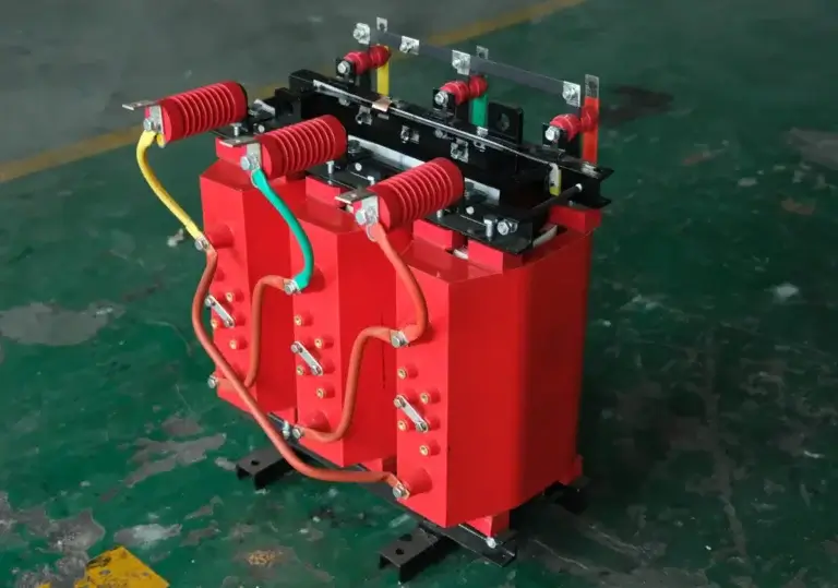 The internal assembly of a 100 kva dry type transformer china featuring solid red cast resin coils on the Baitong Electric factory floor.