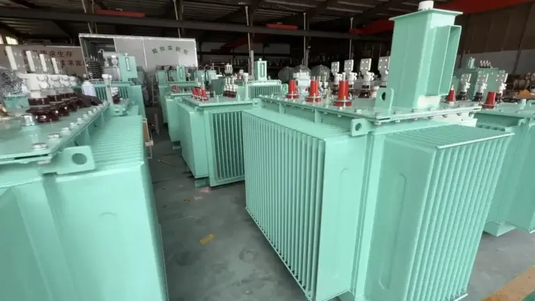 A row of newly manufactured mint-green 20kv oil immersed transformers with corrugated cooling fins on the Baitong Electric factory floor.