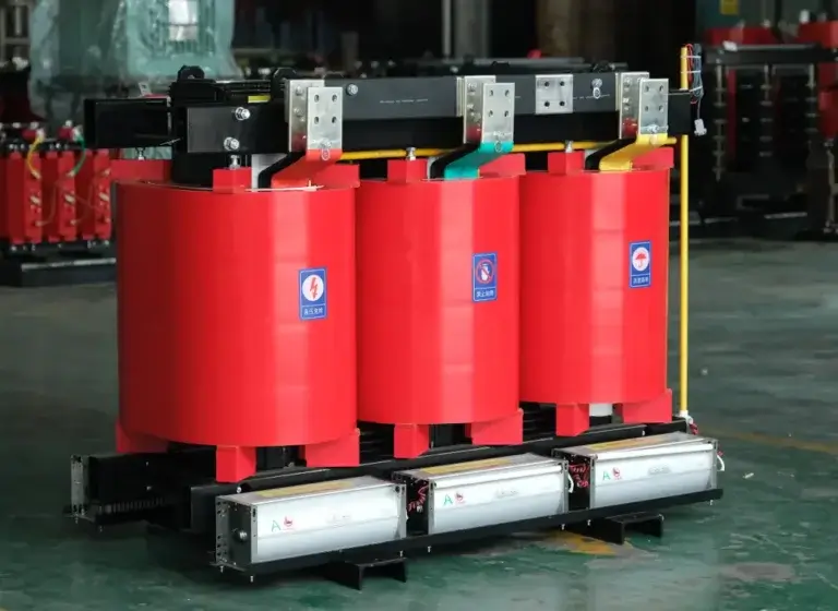 A three-phase cast resin dry-type transformer featuring red coils and bottom aluminum cooling fans on the Baitong Electric factory floor.