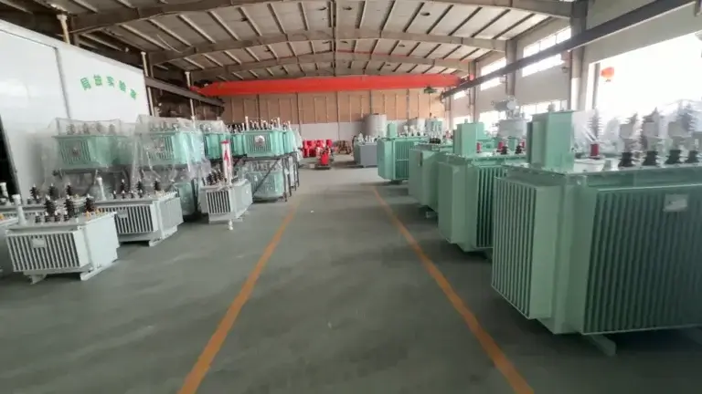 A wide view inside the Baitong Electric china oil immersed transformer factory showing rows of green transformers, a partial discharge testing lab, and clear yellow safety lines.