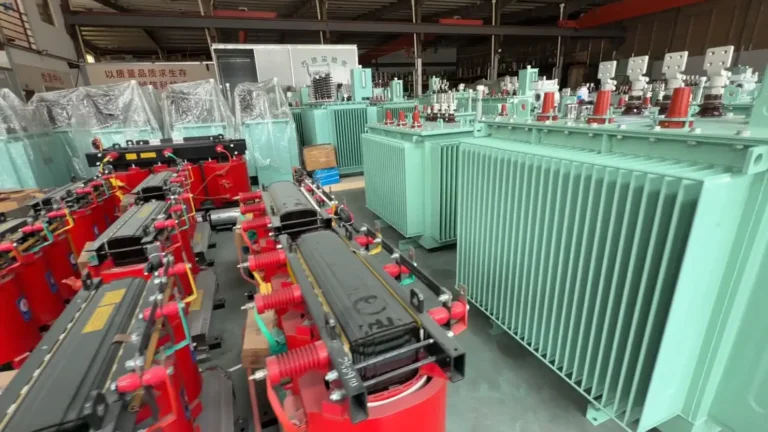 A factory floor view comparing dry type transformer vs oil-immersed transformer, showing red cast resin units next to green corrugated tank units at Baitong Electric.