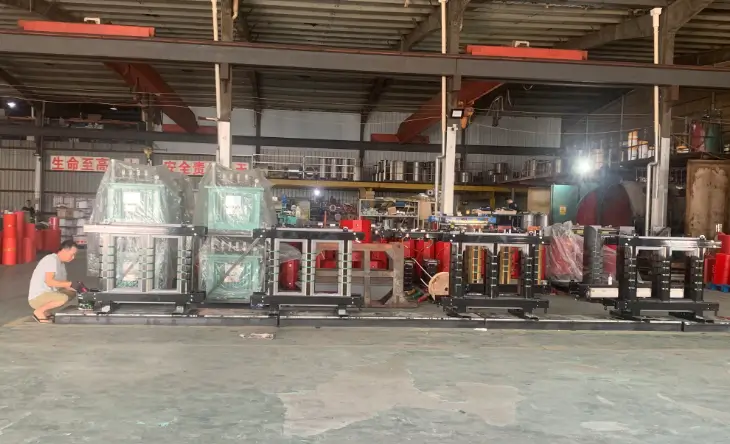 Technician working beside dry type power transformer core and coil assemblies in the BTCN Electric factory
